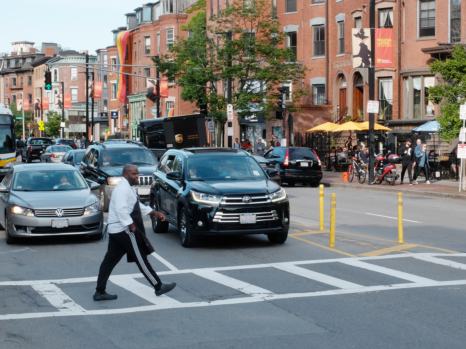 Man walking across Tremont Street. Cars are visible behind him.