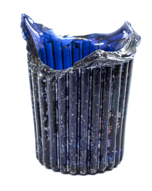 A molded blue glass base of a seed cup for a birdcage