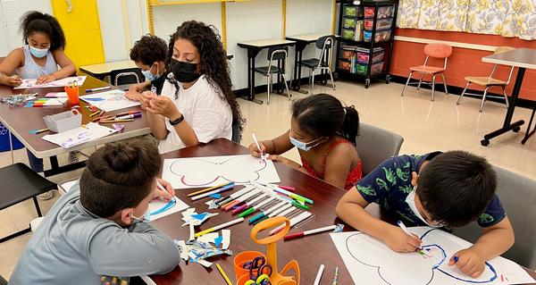 Students decorating butterflies for Immigrant Heritage Month
