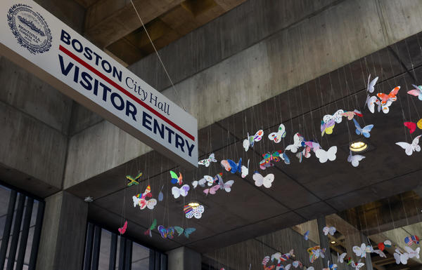 Butterflies to the right of a Visitor sign on the 3rd floor of Boston City Hall
