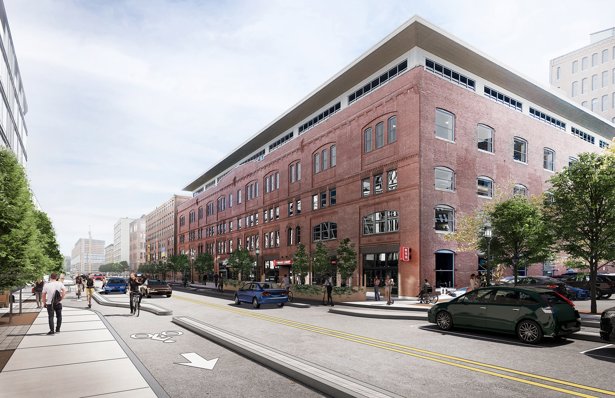 A computer-generated illustration of Congress Street after the reconstruction. Sidewalks are significantly larger and a separated bike lane is between the sidewalk and the two general travel lanes. A built concrete and granite barrier separates the bike lane. More trees are visible.