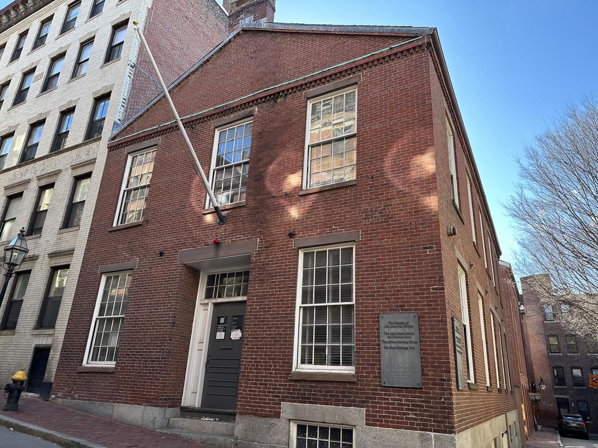 Exterior view of the Abiel Smith School, an 1835 brick building with large windows.
