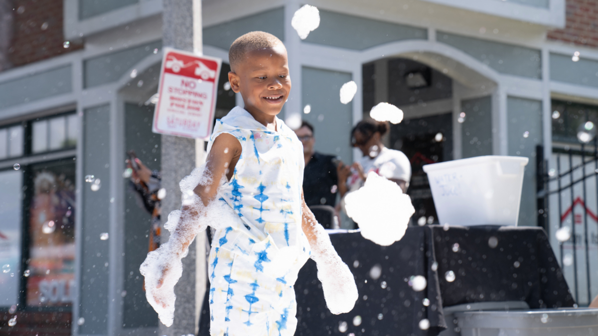Open Streets Boston Kid Playing in Bubbles 