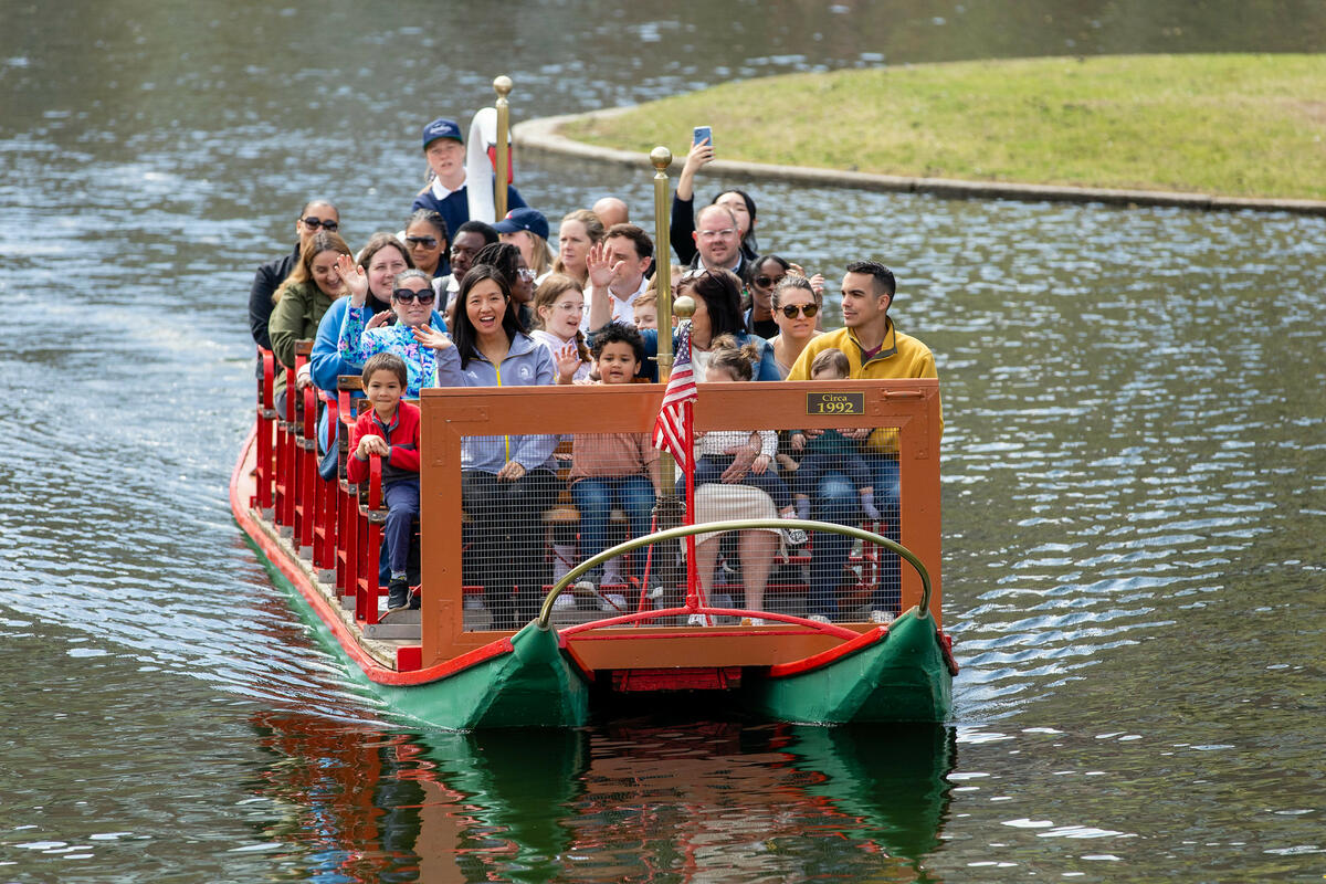 Swan boat in the Public Garden filled with people.