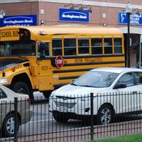 Image for cars and buses driving through roslindale village