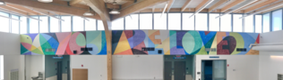 You Are Loved mural inside Engagement Center by Alex Cook